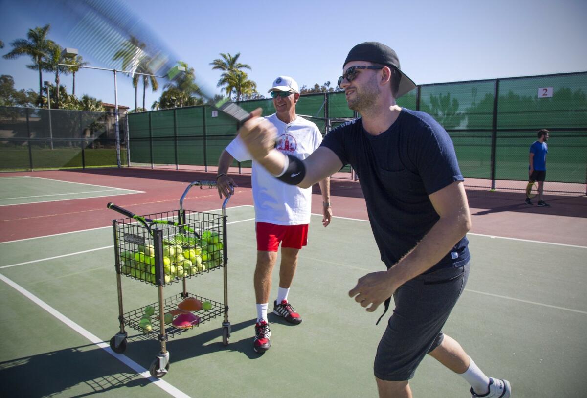 SAN DIEGO, CA-January 26, 2016: | Tennis pro Geoff Griffin gives on as actor Patrick J. Adams who stars as tennis player Tim Porter in the World Premiere of The Last Match at the Old Globe Theatre opening February 13, a tennis lesson at the Balboa Tennis Club. It's the story of Tim Porter, an American superstar tennis player as he battles Russian phenom Sergei Sergeyev in the US Open tennis semifinals. | (Howard Lipin / San Diego Union-Tribune) San Diego Union-Tribune