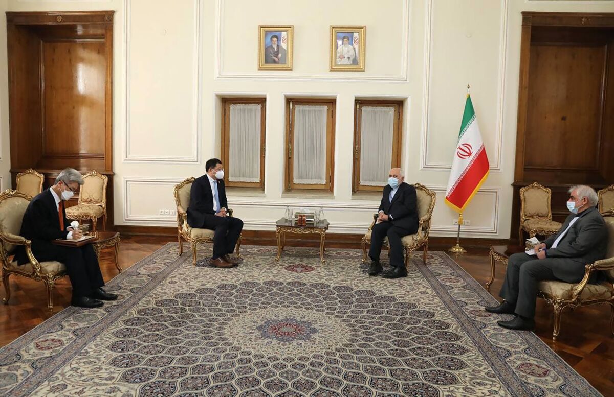 In this photo released by the Iranian Foreign Ministry, South Korean Vice Foreign Minister Choi Jong Kun, center left, speaks with Iranian Foreign Minister Mohammad Javad Zarif, center right, during their meeting in Tehran, Iran, Monday, Jan. 11, 2021. Iran’s foreign minister on Monday told the visiting South Korean delegation that the release of a Korean vessel and its crew seized by Iranian forces is a matter for the courts and out of the administration's hands, state media reported. (Iranian Foreign Ministry via AP)
