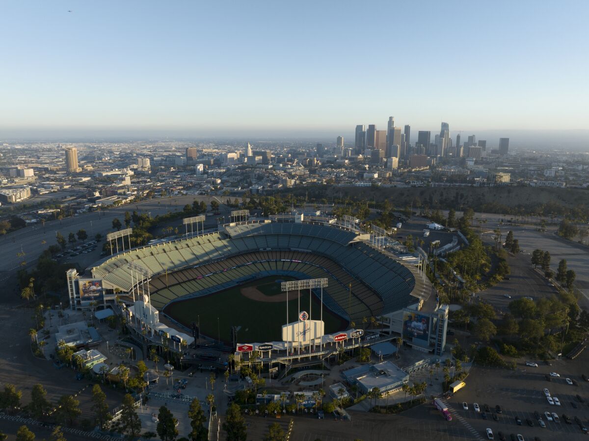 A view of Dodger Stadium with downtown Los Angeles in the background.