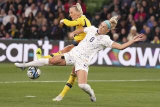 Sweden's Stina Blackstenius and United States' Julie Ertz, right, battle for the ball.