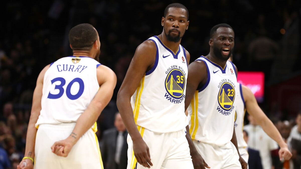 Kevin Durant, center, celebrates with Stephen Curry and Draymond Green during Game 3 of the 2018 NBA Finals against the Cleveland Cavaliers. Are we seeing the end of the Warriors’ dynasty?