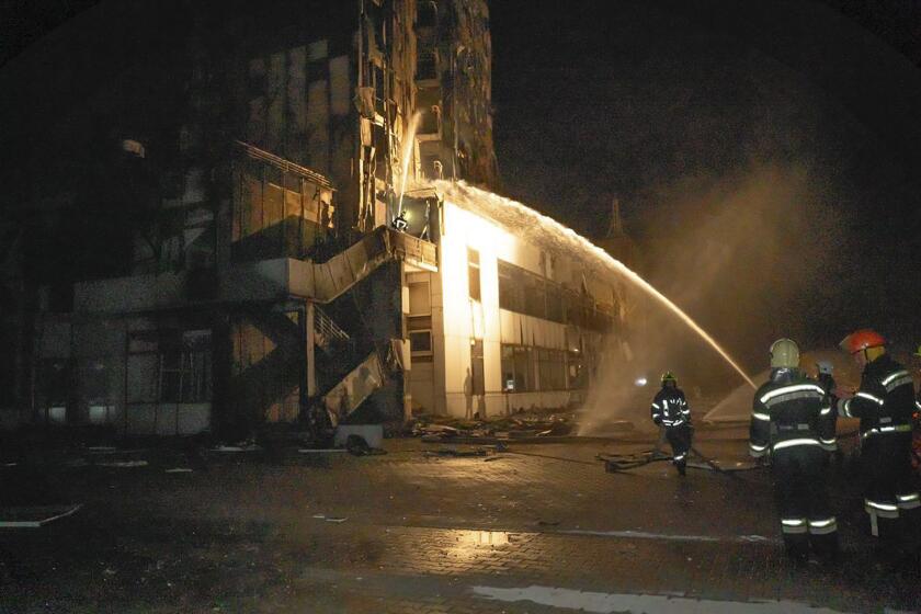 In this photo provided by the Odesa Region Administration, firefighters work to extinguish a fire in a hotel at the seaport after a Russian rocket attack in Odesa, Ukraine, Monday, Sept. 25, 2023. (Odesa Region Administration via AP)