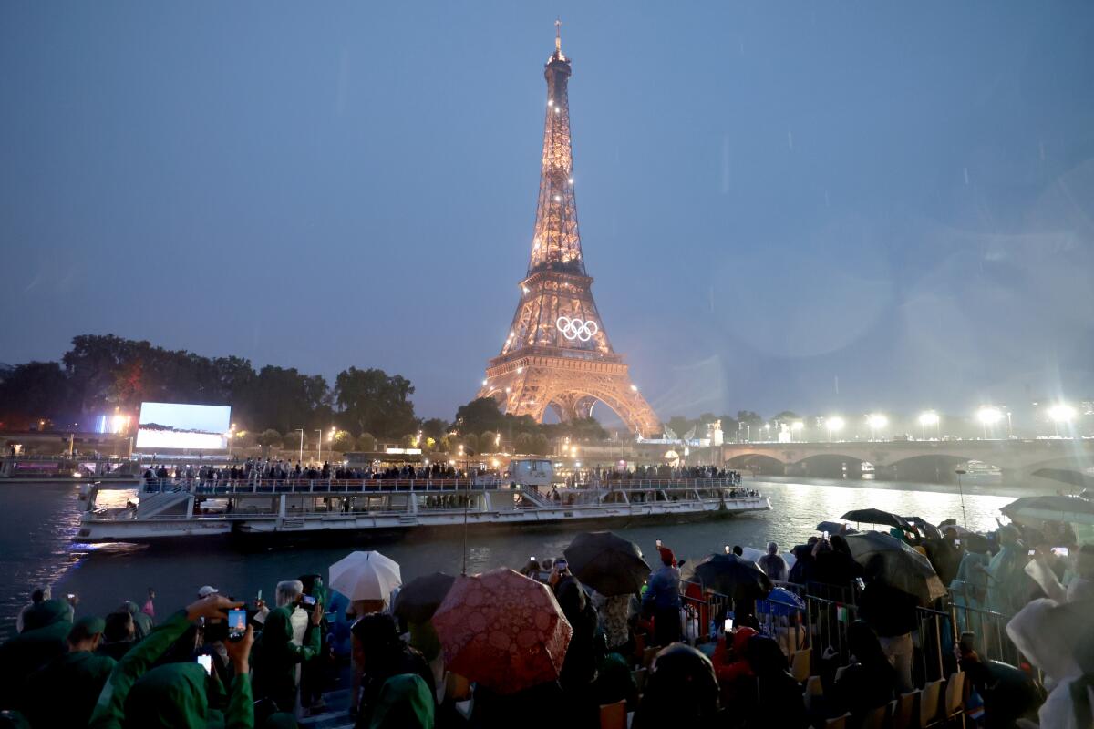 Fans watch Team USA as it moves past them on the Seine River during the Paris Olympics opening ceremony Friday.