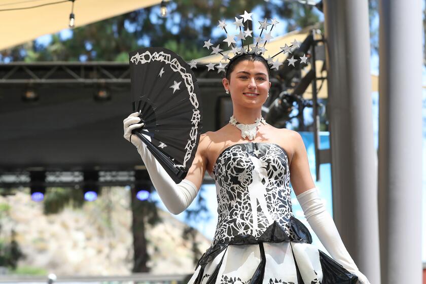 Lucy Landherr models a dress down the runway by artist Nancy Swan