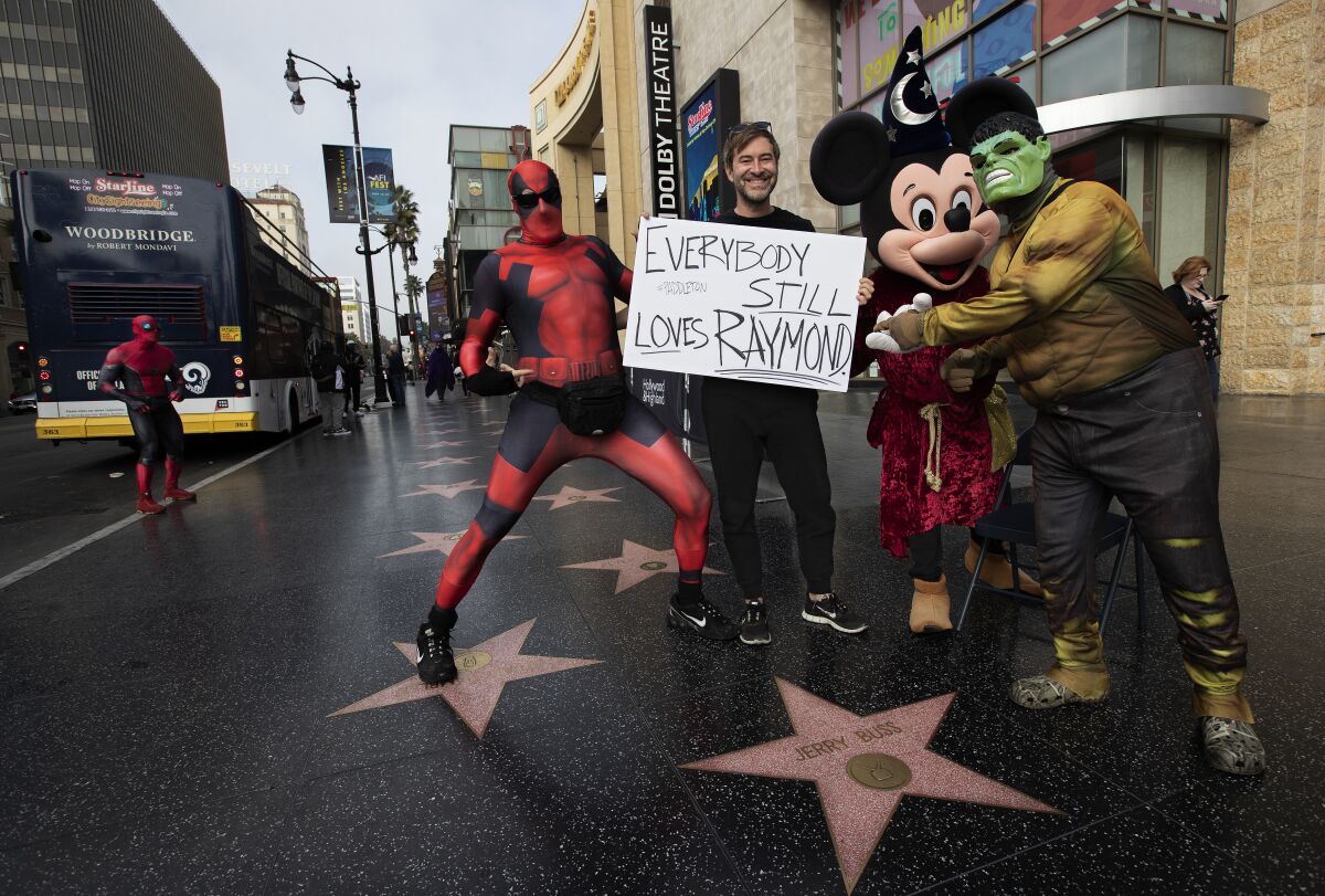 Mark Duplass stands with characters on Hollywood Boulevard.