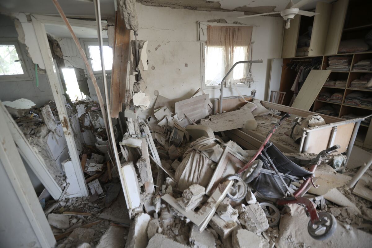 A view of piled-up rubble and smashed walls inside a home.