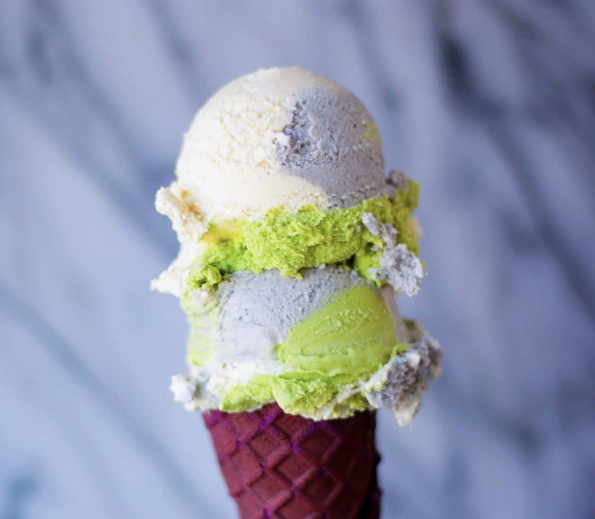 Japanese Neapolitan on an ice cream cone, a trio of matcha, hojicha and black sesame.
