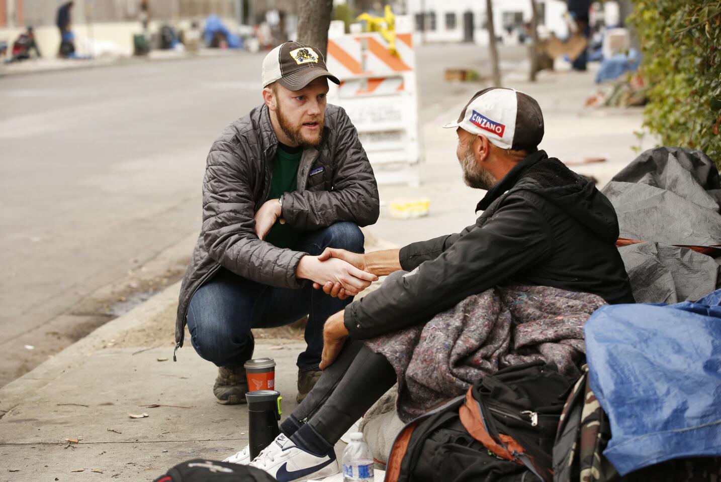 Stephen Butler, left, of the St. Joseph Center talks with Jack on a sidewalk on Rose Avenue in Venice. St. Joseph is leading what is called a C3 outreach team offering services to the homeless.