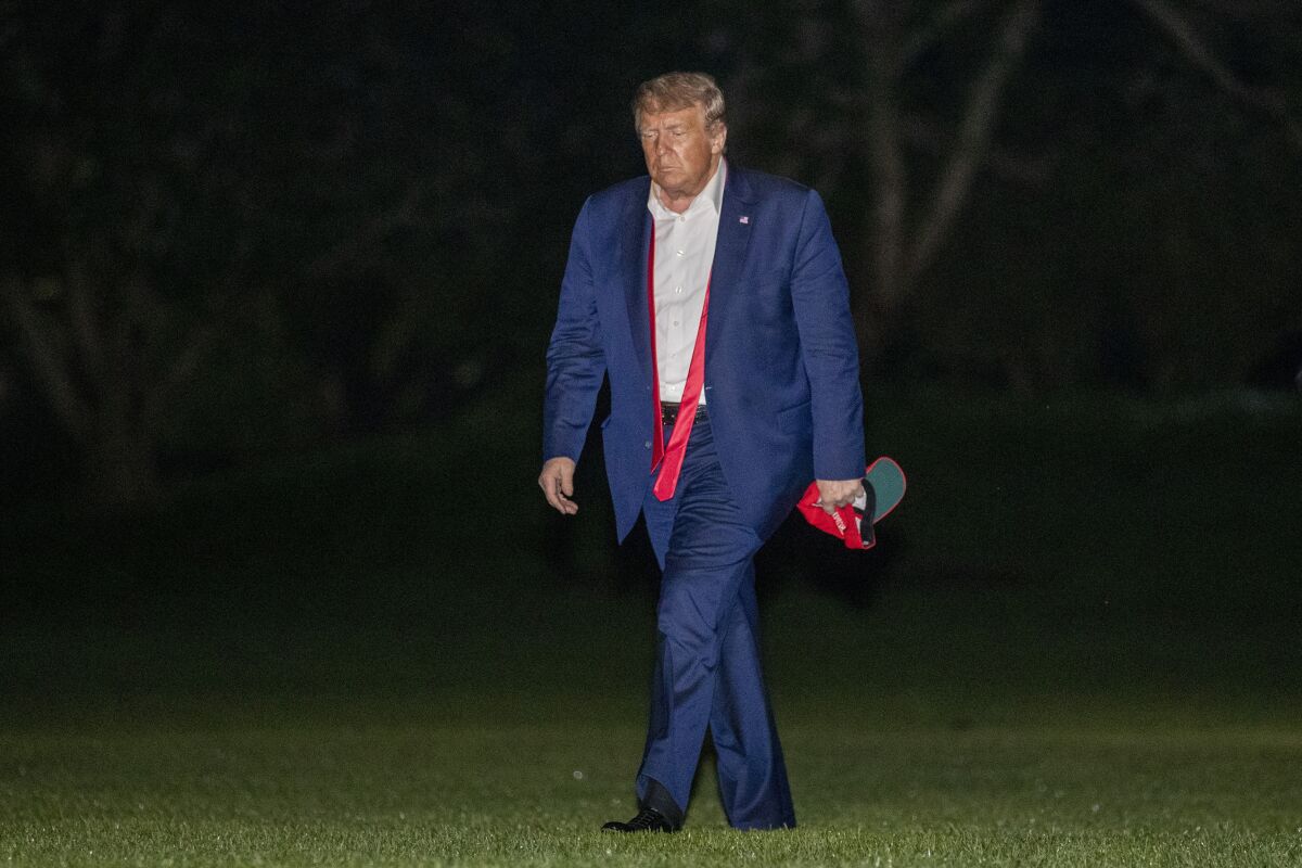  President Trump walks on the South Lawn of the White House after stepping off Marine One.