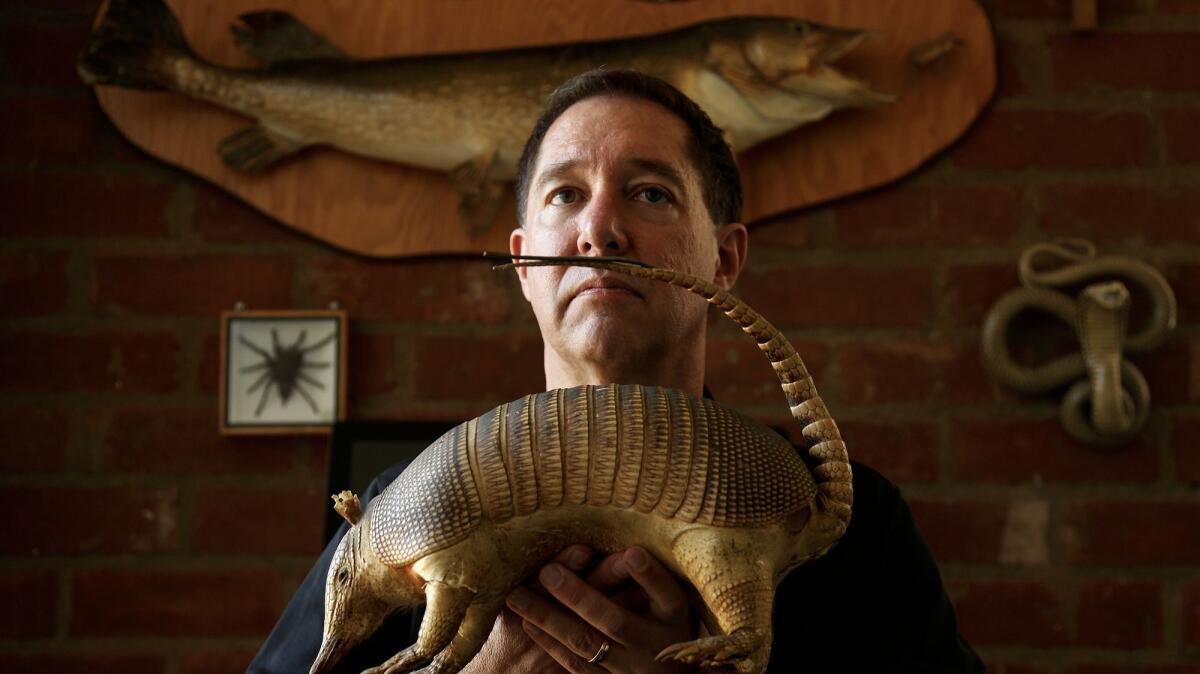 Playwright Tom Jacobson hangs out with some taxidermied critters at home. By day he raises funds for the Natural History Museum of Los Angeles County.