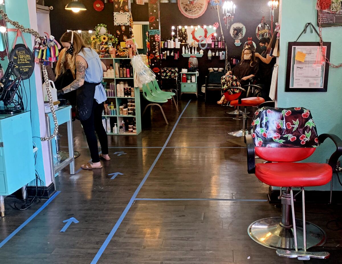 At Rockabetty's Hair Parlor in Yuba City, a walkway drawn from the salon's entrance to hair styling chairs promotes social distancing.