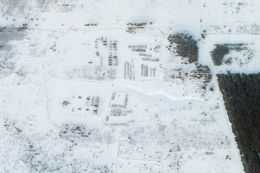 This satellite image shows vehicles and tanks stationed at a snowy training area