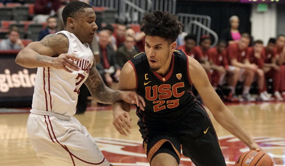 USC forward Bennie Boatwright (25) drives past Washington State guard Charles Callison during the second half Saturday.