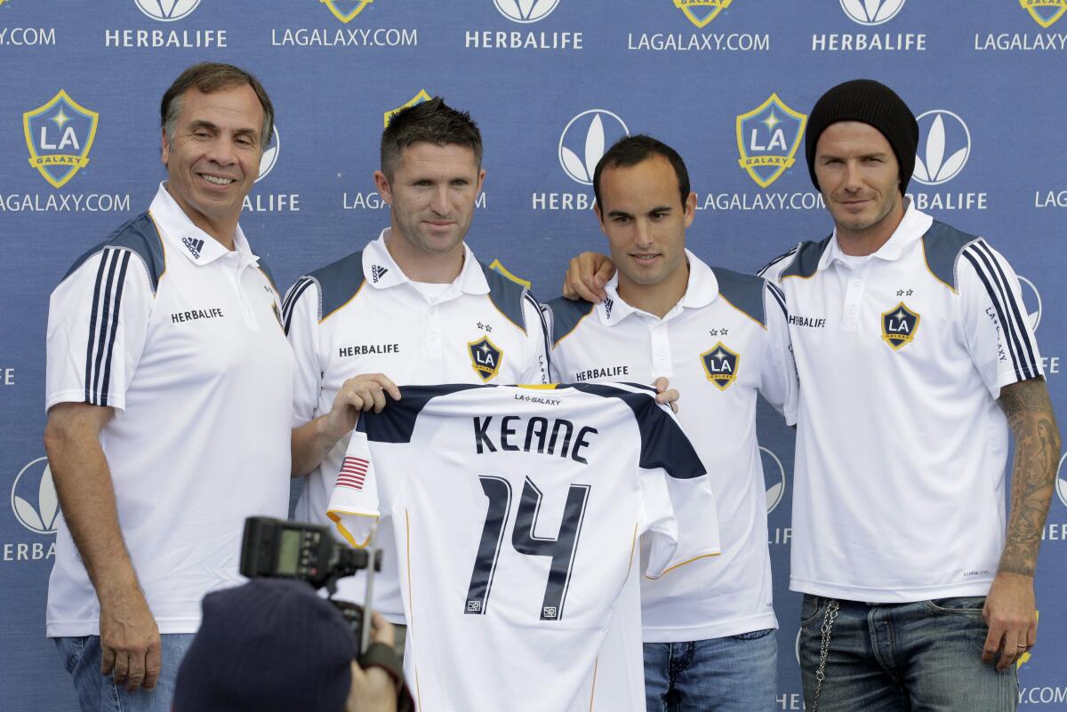 Galaxy coach Bruce Arena, Robbie Keane, Landon Donovan and David Beckham pose for a photo during a 2011 news conference 