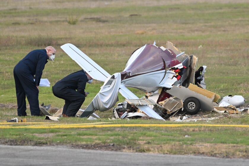 Torrance, California November 30, 2022-Investigators look over a plane that crashed and killed two people at Torrance Airport Wednesday morning. (Wally Skalij/Los Angeles Times)