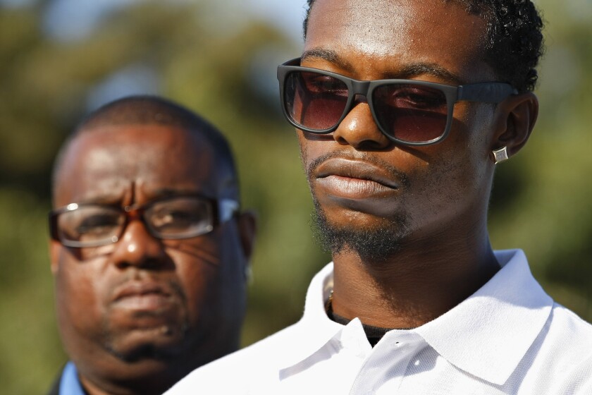 Clinton Alford Jr. 22, right, and his father Clinton Alford Sr., at a news conference in South Los Angeles on April 20.