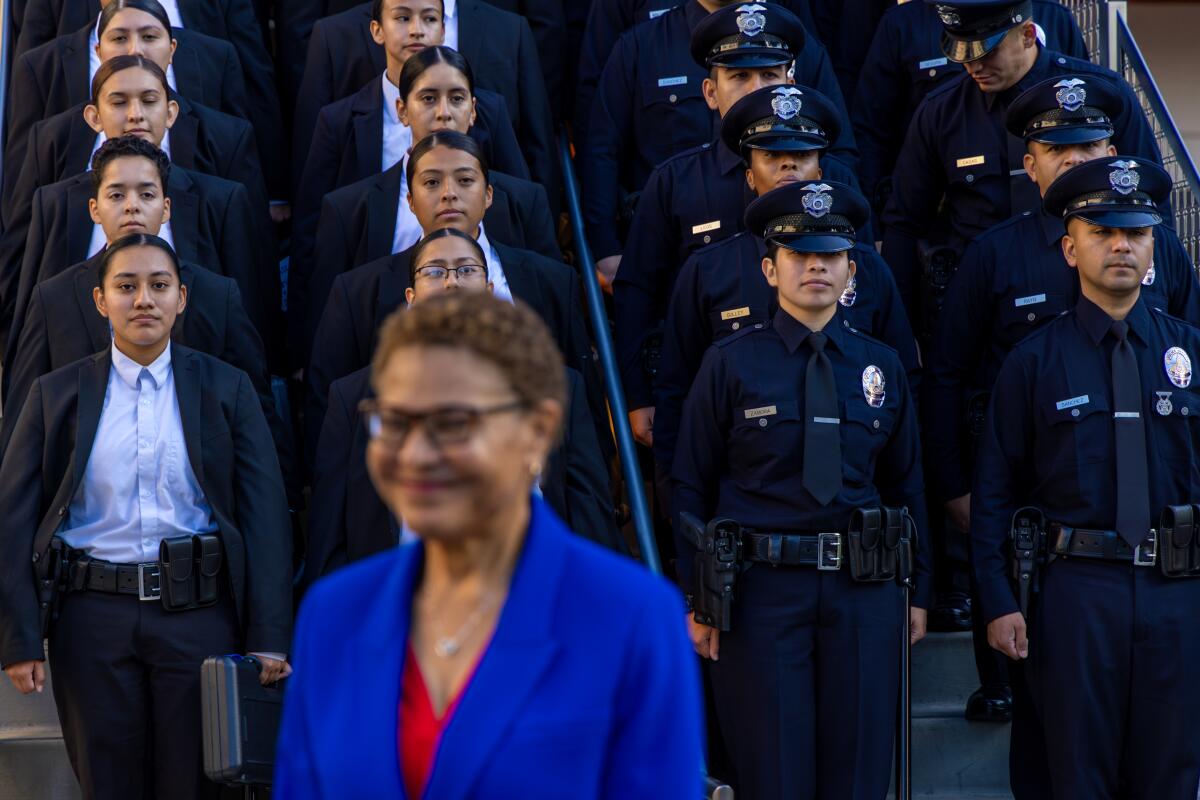 Mayor Karen Bass in front of police recruits and uniformed officers standing at attention in rows behind her