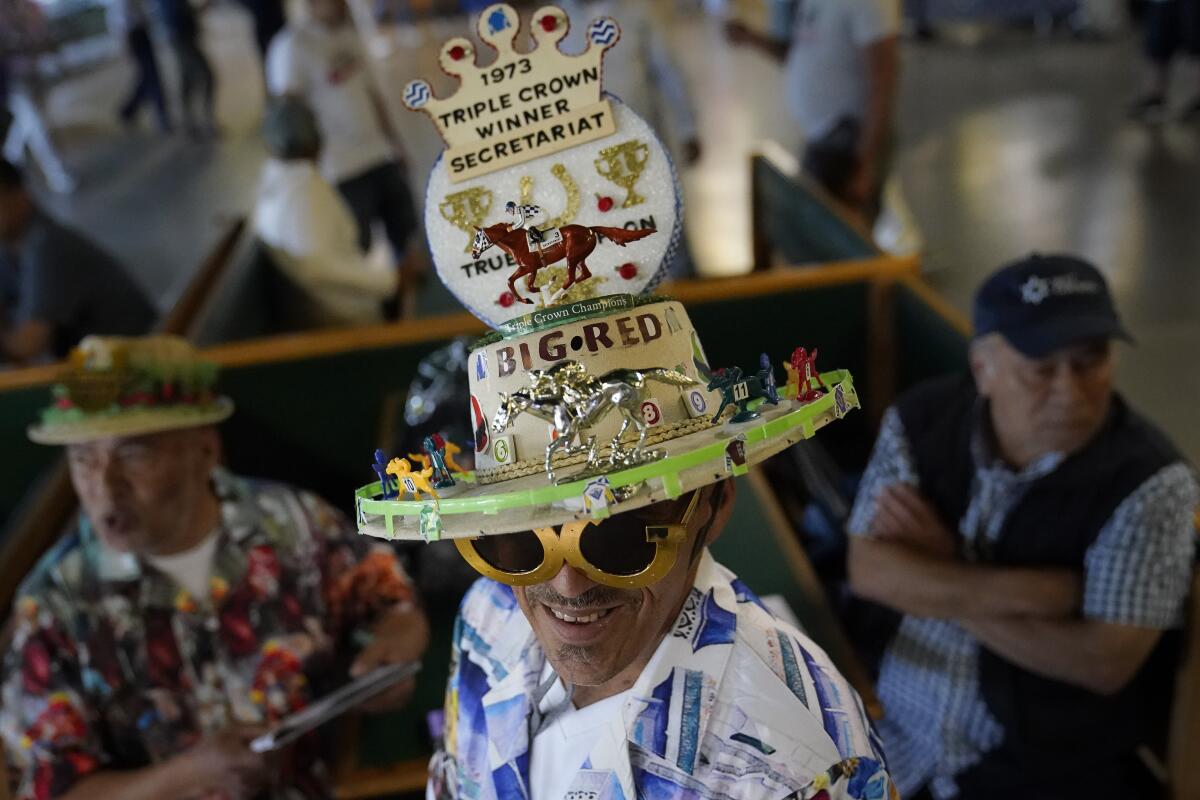 A spectator at Belmont Park on Saturday wears a hat celebrating the 50th anniversary of Secretariat's Triple Crown win.