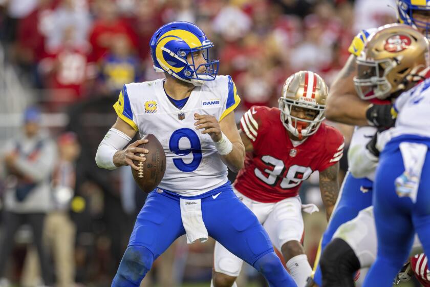 Rams quarterback Matthew Stafford drops back to pass against the San Francisco 49ers on Oct. 3, 2022.