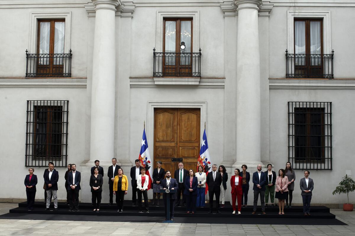 Chile's President Gabriel Boric, center, speaks