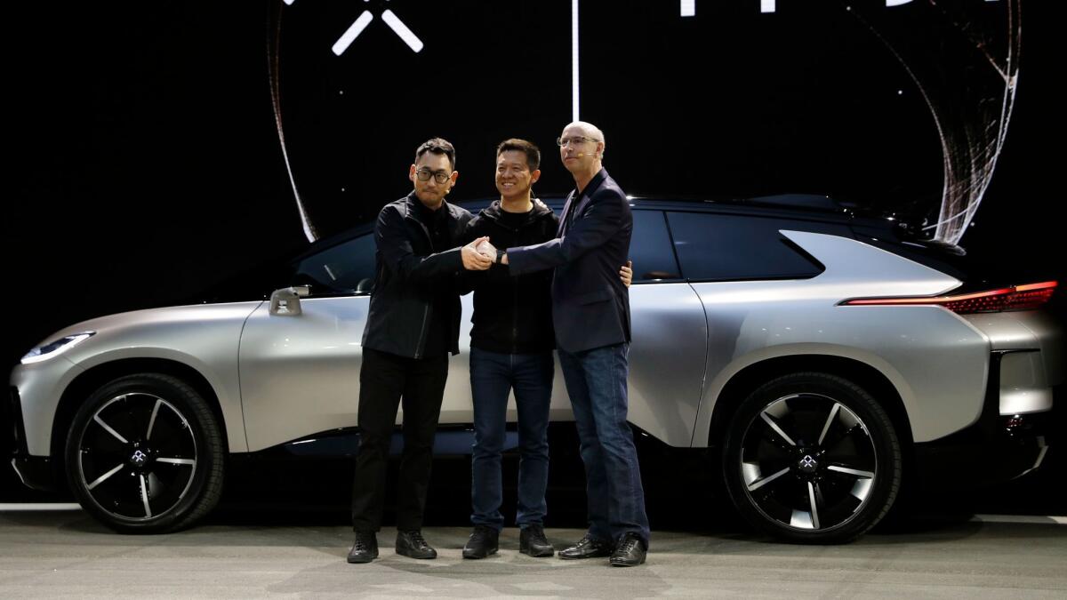 Chinese entrepreneur Jia Yueting, center, poses with Faraday Future executives Richard Kim, left, and Nick Sampson in January 2017. Kim has since left the company.