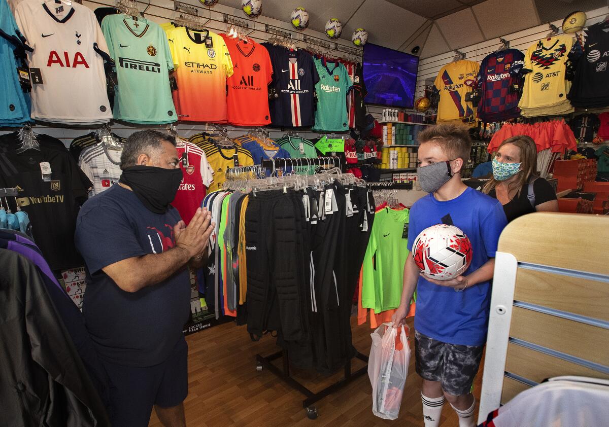 Carlos Marroquin, owner of Planet Soccer in Newhall, thanks customers.
