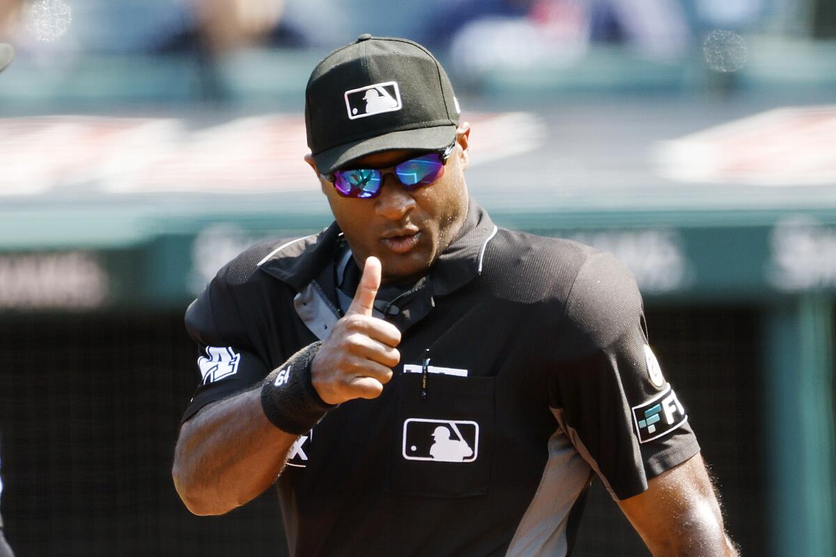 FILE - Umpire Alan Porter signals before a baseball game between the Chicago White Sox and the Cleveland Guardians, Thursday, Sept. 15, 2022, in Cleveland. Adrian Johnson and Alan Porter became Major League Baseball’s second and third Black umpire crew chiefs as the sport announced 10 retirements along with promotions from the minors, Thursday, Jan. 19, 2023.(AP Photo/Ron Schwane, File)