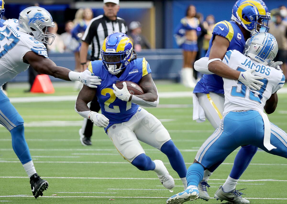 Rams running back Darrell Henderson Jr. looks for room to run against the Lions.