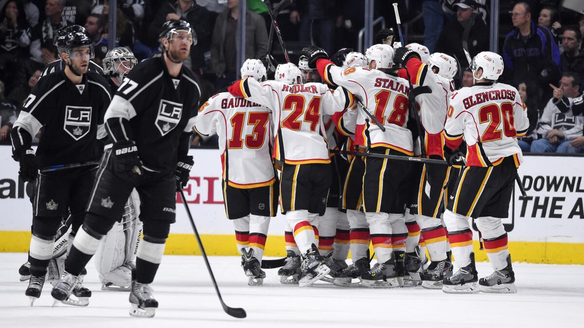 Calgary Flames players celebrate Mark Giordano's overtime goal at the end of the Kings' 4-3 loss at Staples Center on Monday.