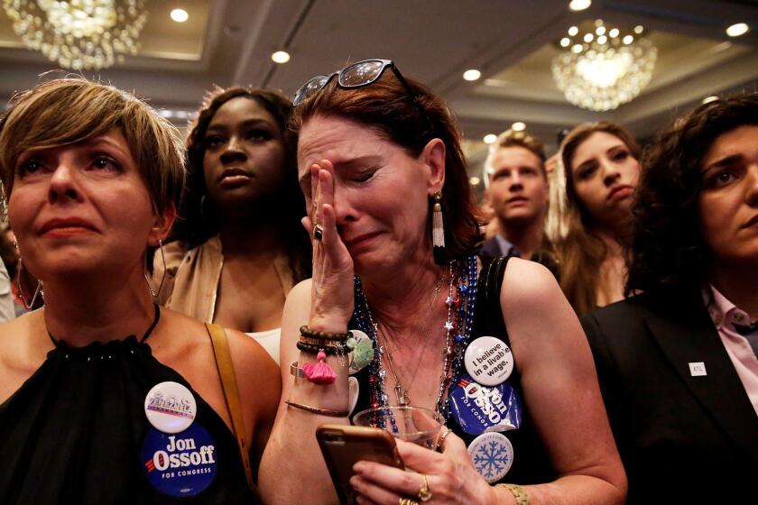 Supporter Jan Yanes, center, cries as Democratic candidate for 6th congressional district Jon Ossoff concedes to Republican Karen Handel at his election night party in Atlanta, Tuesday, June 20, 2017. (AP Photo/David Goldman)