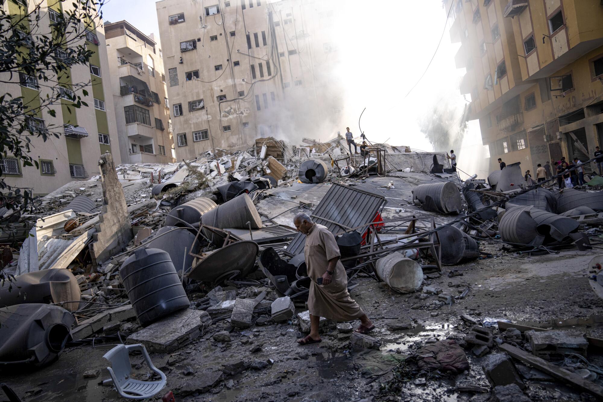Palestinians inspect the rubble of a building after it was struck by an Israeli airstrike in Gaza City. 