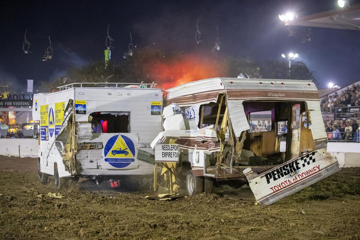 Oscar Yomamato, left, and Scott Loughner, right, collide during the Motorhome Madness demolition derby.