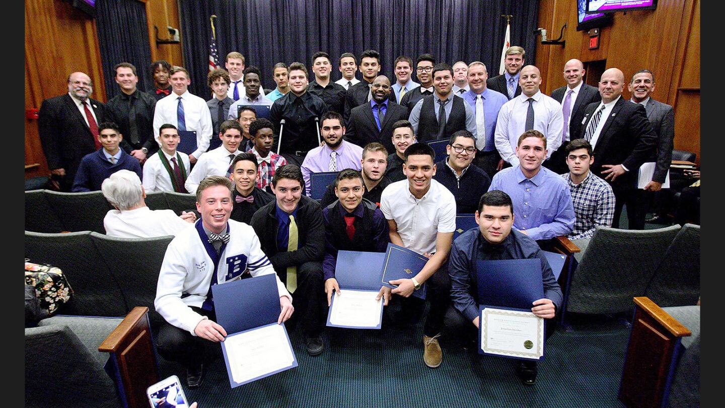 The Burbank Football team, with coaches and members of the School Board, pose with their certificates after being honored at a regular meeting of the Burbank Unified School District Board of Education at Burbank City Hall on Thursday, February 2, 2017. The Burbank High School football team was honored for being California Interscholastic Federation Southern Section Division 9 Championship finalists. Coach Richard Broussard, who recently stepped down, was there as well as most of the football team.
