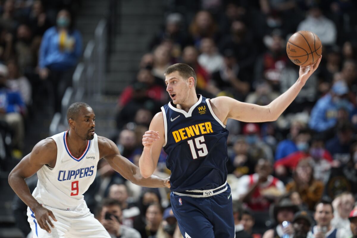 Denver Nuggets center Nikola Jokic catches a pass in front of Clippers center Serge Ibaka.
