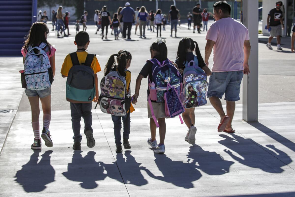 Students walk walk into Sunkist Elementary School in Anaheim 