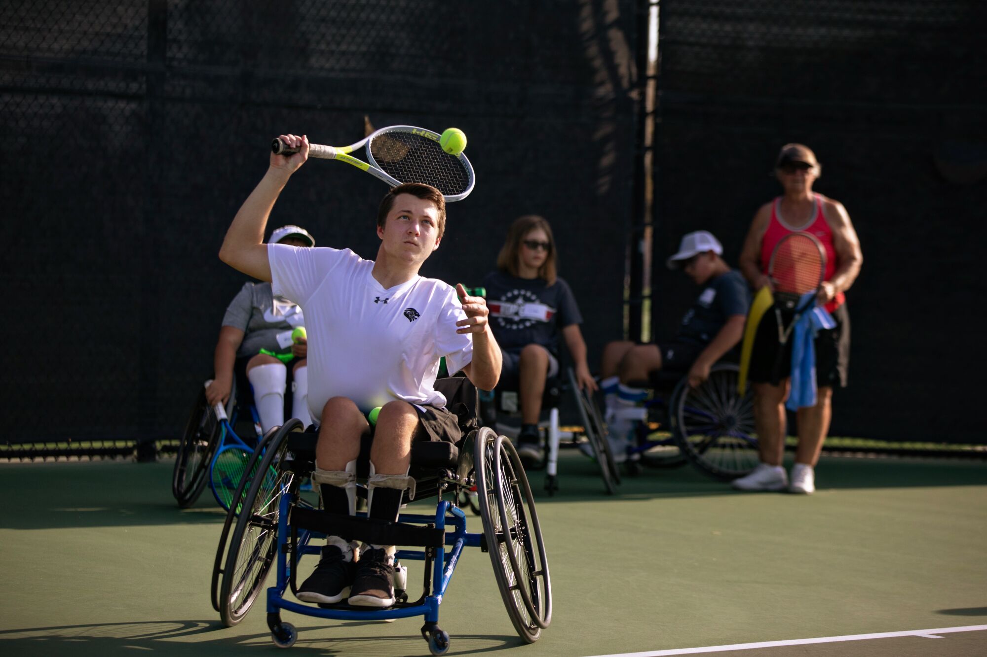 Landon Sachs swings his racket overhead during a tennis practice at JSerra High School.