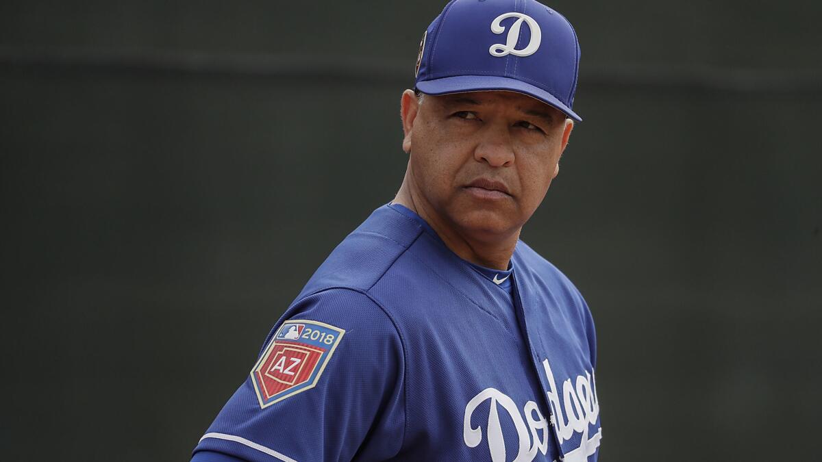 Dodgers manager Dave Roberts watches over a spring training workout at the Camelback Ranch complex.
