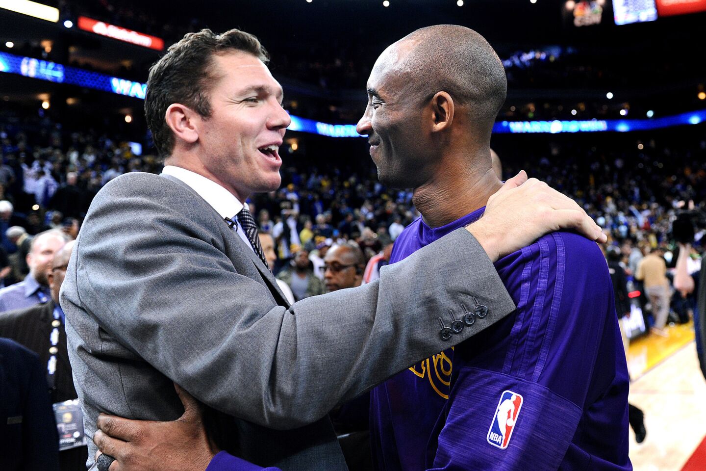 Kobe Bryant hugs former Lakers teammateand current Warriors assistant coach Luke Walton after a game in Oakland on Jan. 14, 2016.