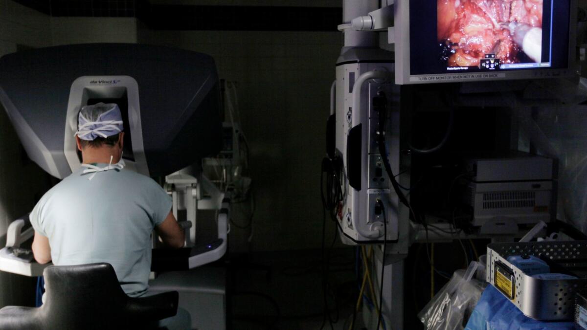 A surgeon performs a robotic prostatectomy on a patient in Chicago. Because of knowledge from clinical trials and improved surveillance tools, men are feeling a lot more confident about delaying treatment in favor of monitoring, says Dr. Jeffrey Yoshida of Hoag Hospital.