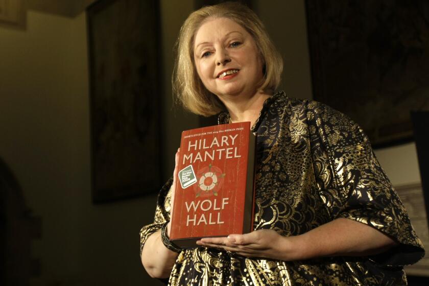FILE - Winner of the 2009 Booker Prize for fiction Hilary Mantel with their book ' Wolf Hall ' poses for photographers following the announcement in central London, on Oct. 6, 2009. Mantel, the Booker Prize-winning author of the acclaimed “Wolf Hall” saga, has died, publisher HarperCollins said Friday Sept. 23, 2022. She was 70. (AP Photo/ Alastair Grant, File)