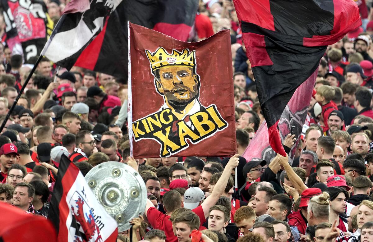 Bayern Leverkusen fans hold up a banner depicting coach Xabi Alonso during a match against Werder Bremen on Sunday.