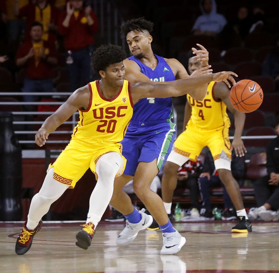 USC guard Ethan Anderson slaps the ball away from Florida Gulf Coast guard Cyrus Largie during the second half.
