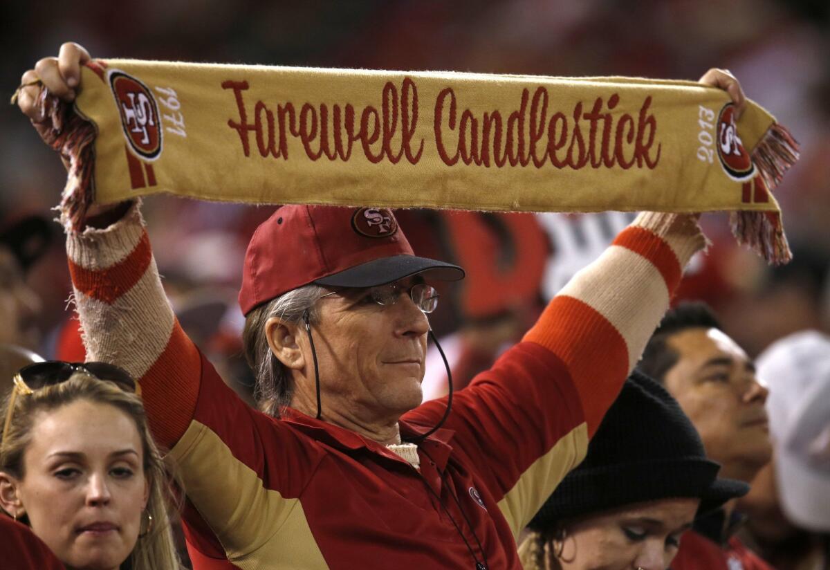 A 49ers fan holds up a scarf during the team's game Monday against the Atlanta Falcons at Candlestick Park in San Francisco.