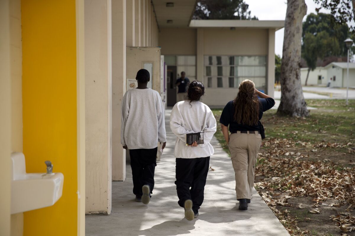 Female detainees carry books from the library. “In my own way, I’m doing my own civil rights initiative,” said Gallegos, who advocated for the library to inspire the readers she teaches in the juvenile hall.