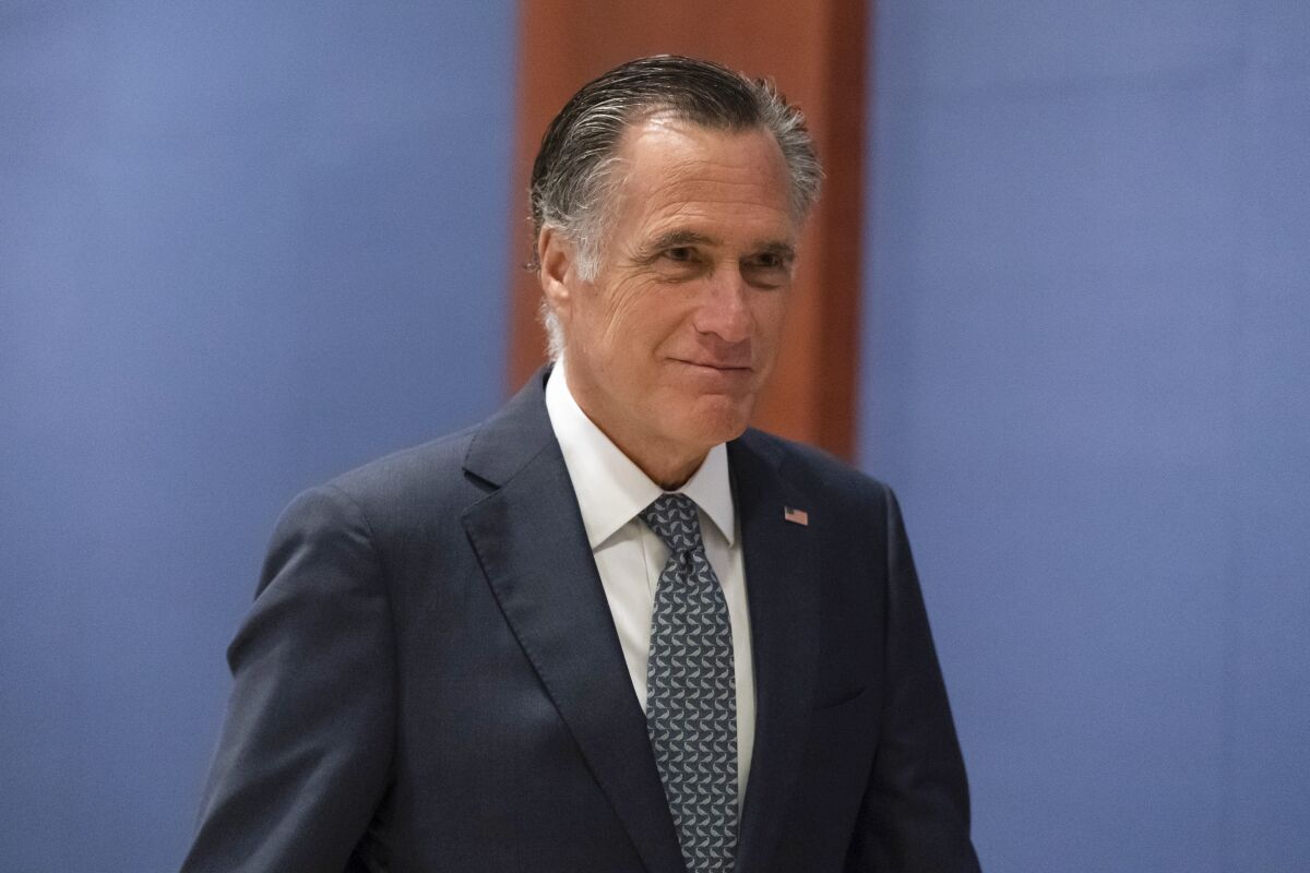 Sen. Mitt Romney, R-Utah, arrives to watch a speech by Ukrainian President Volodymyr Zelenskyy live-streamed into the U.S. Capitol, in Washington, Wednesday, March 16, 2022. Zelenskyy has been pleading with the U.S. for military support against Russia's crushing invasion. (AP Photo/Alex Brandon).