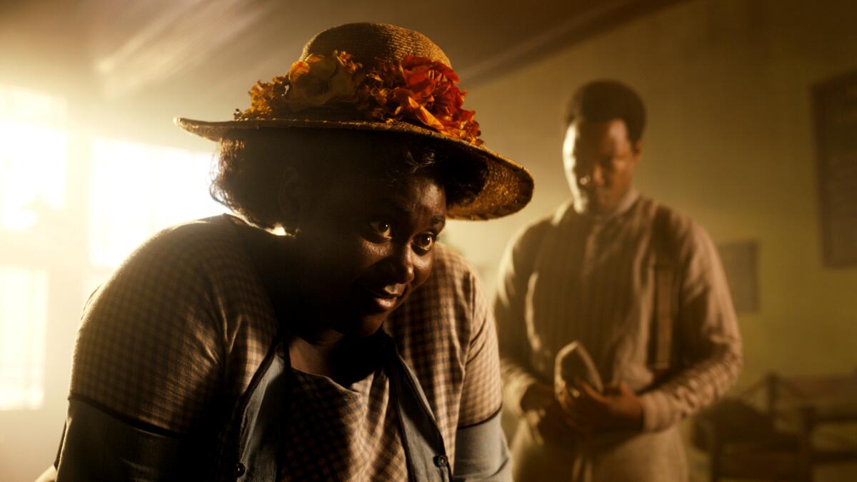 In 1920s rural Georgia, a strong-willed Black woman leans in to confront her potential father-in-law (not pictured).