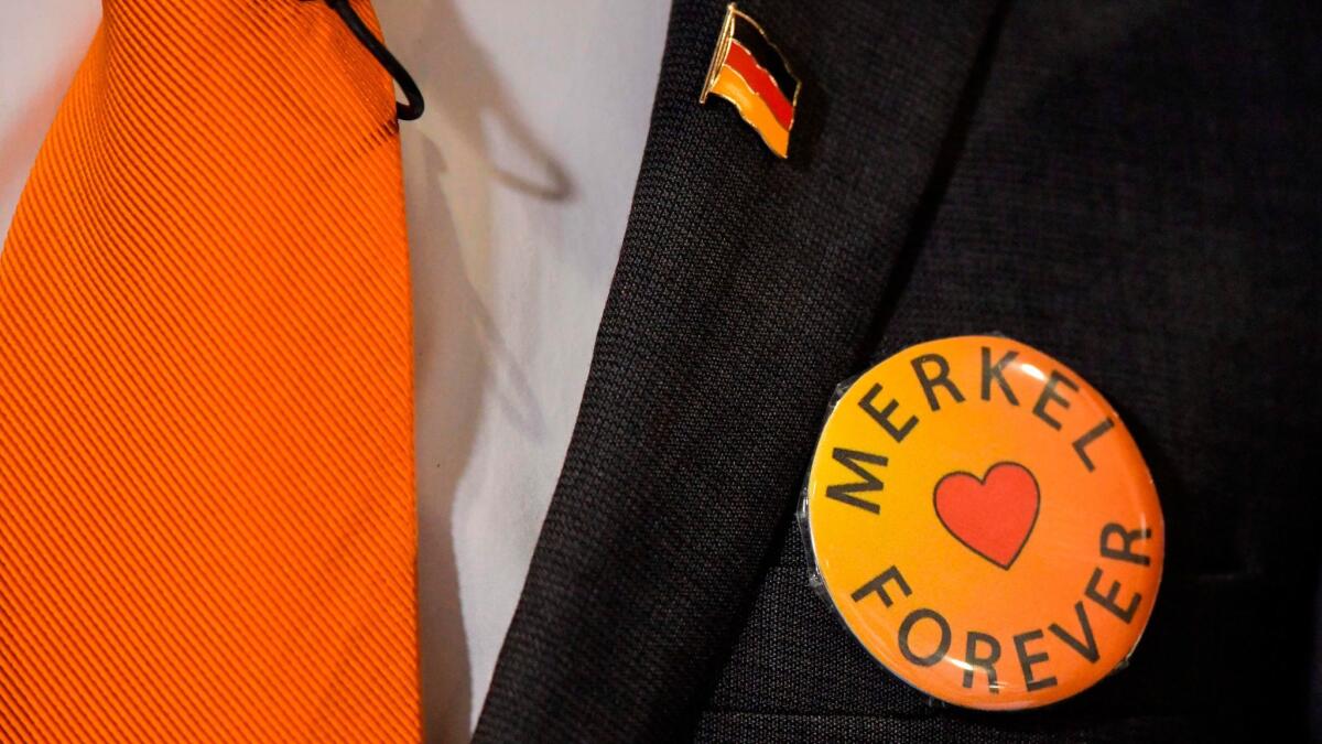 A delegate at the congress of Germany's Christian Democratic Union party wears a pro-Merkel badge on Feb. 26, 2018, in Berlin.