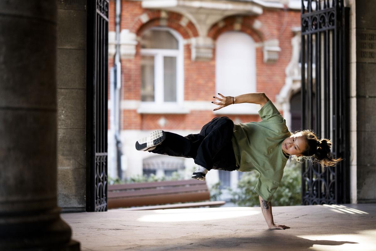 A young woman break dances