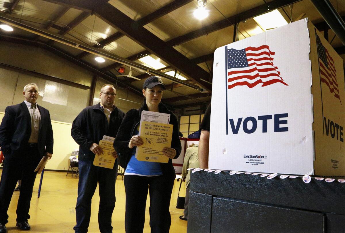 Residents of Bradfordton, Ill., line up to vote in the Illinois primary last year.