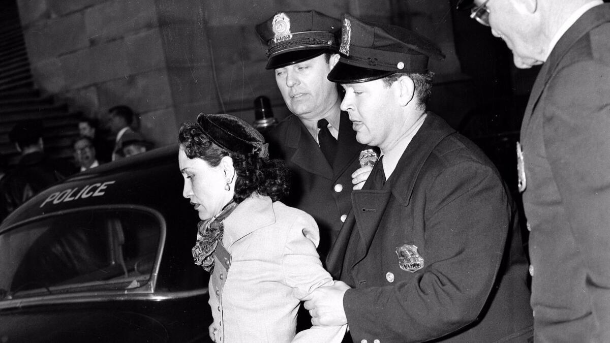 Puerto Rican nationalist Lolita Lebron is led away by police after she and others began shooting in the House chamber at the Capitol in 1954. (Associated Press)